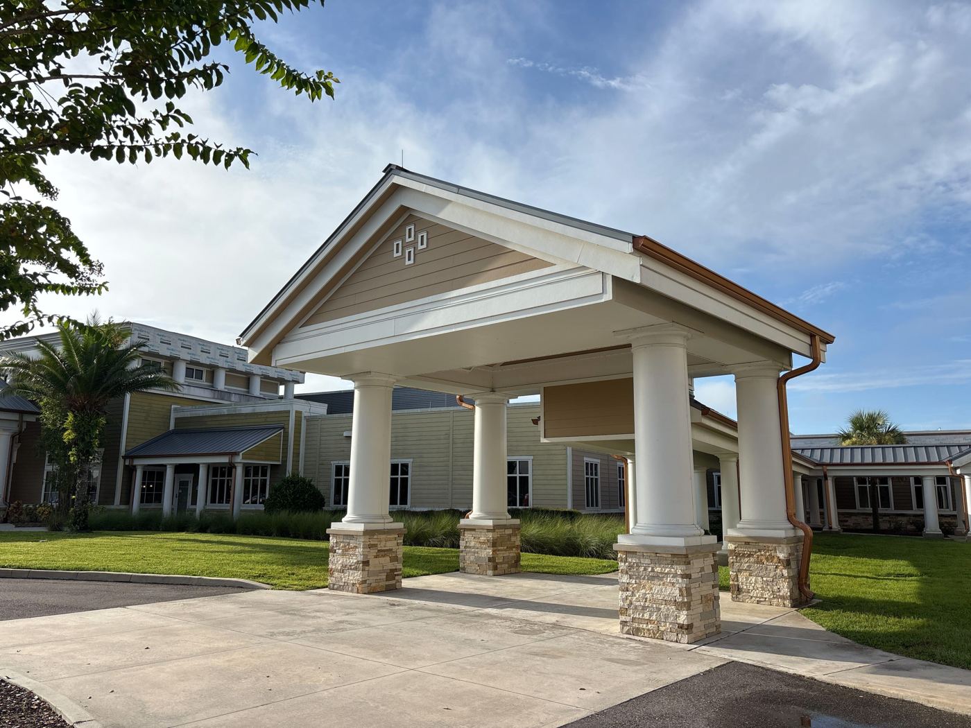 Finished hospital entrance canopy with new siding and trim after the exterior restoration.
