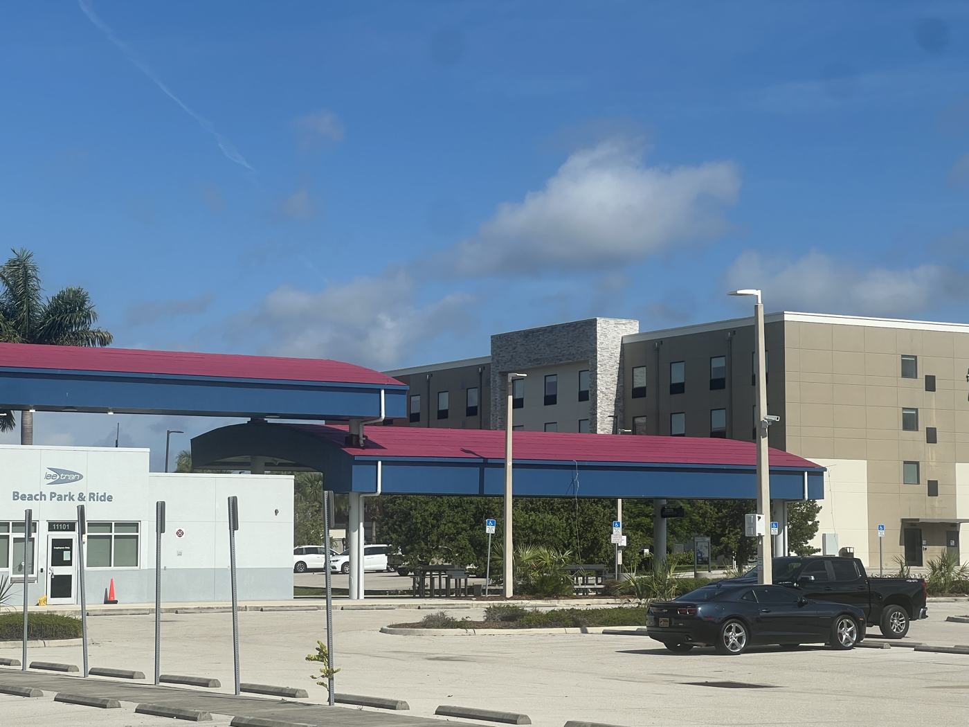 LeeTran Beach Park and Ride before work, with faded red canopy roofs.