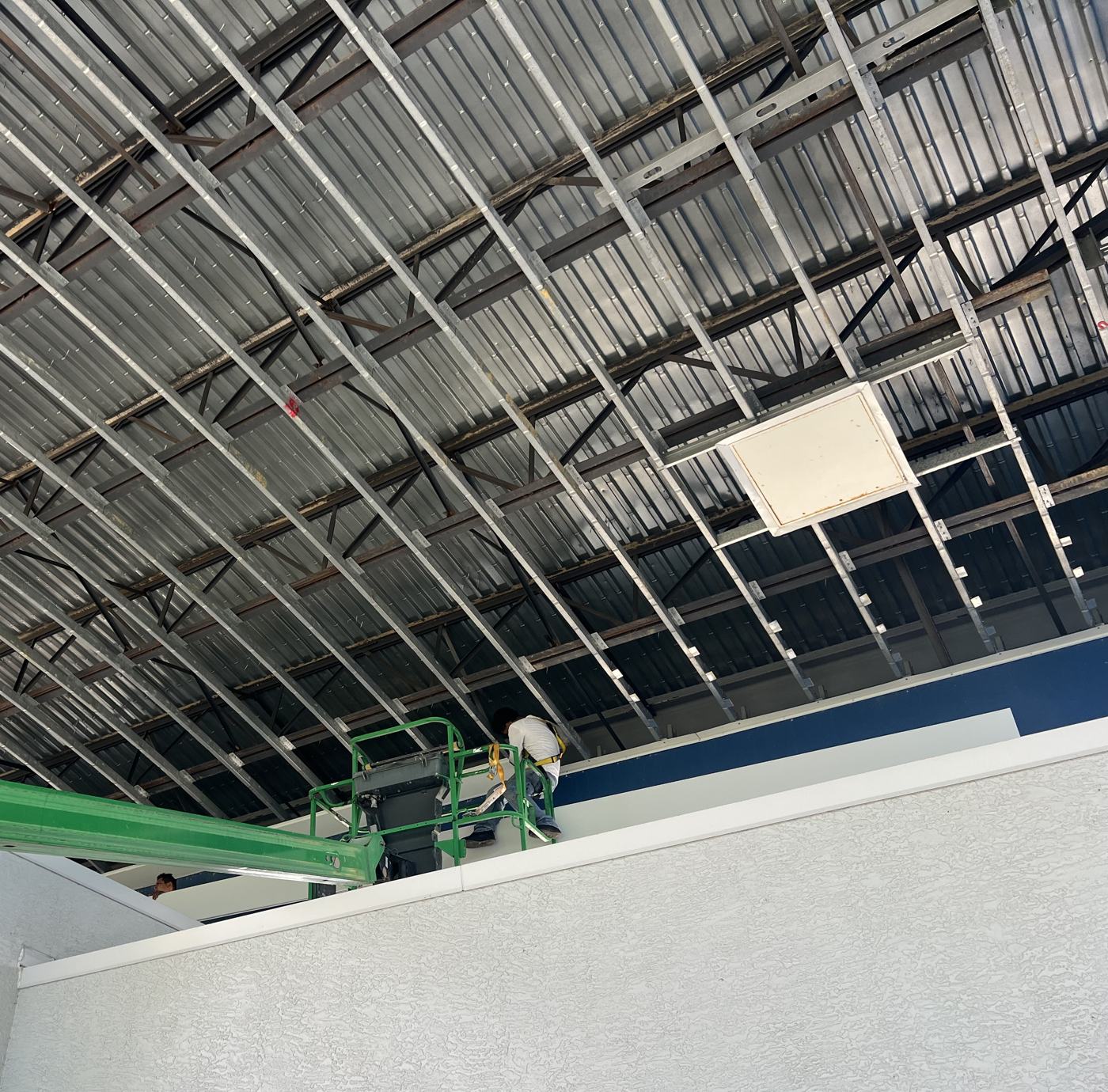 Canopy underside stripped to bare steel structure, lift in position.